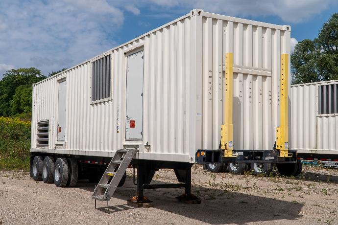 CAT XQ2000 towable generator in a parking lot with stairs mounted